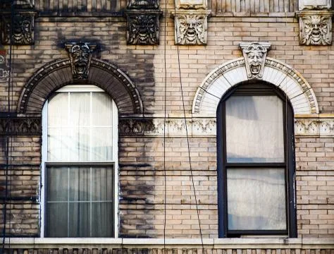Brick wall with two windows Stock Photos