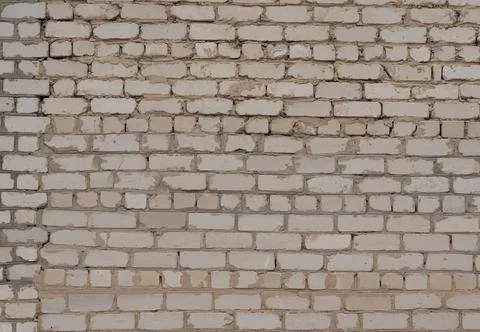 Brick wall. A wall that was being completed and attached to another wall. Stock Photos