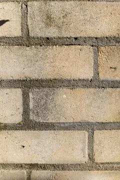 Brick wall in warm sunlight showcasing texture and details of a unique urba.. Stock Photos