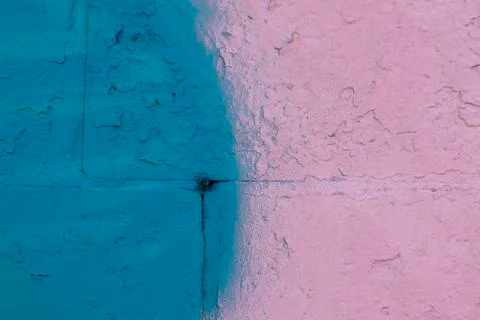 The brick wall was painted with blue and pink spray paint Stock Photos