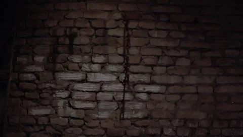 A brick wall on which hangs an old chain and an iron hook Video stock 247019341