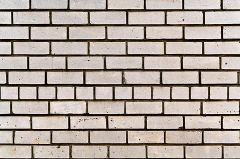 Brick wall with white masonry, uniform pattern, textured surface. Foto stock