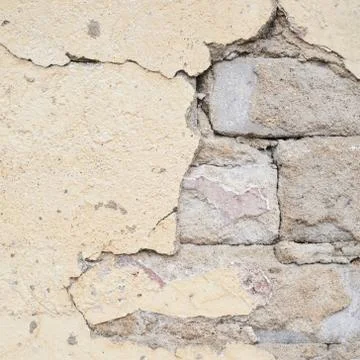 Brick wall with the whitewash falling off Stock Photos