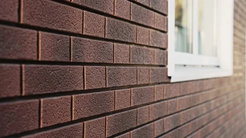 Brick wall with a window close-up. Siding with plastic facade panels Stock Footage 166839086