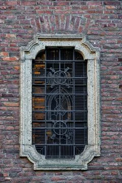 Brick Wall Window with Decorative Iron Grille Stock Photos
