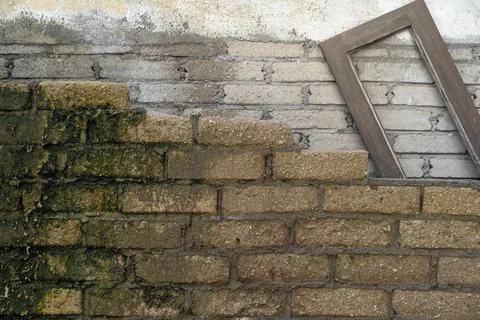 Brick wall with a window frame on top of it Stock Photos