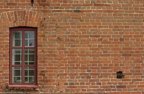 Brick wall with a window in an old building, can be used as a backdrop or bac Fotos de archivo