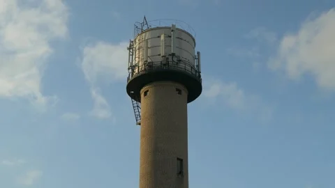Brick water tower with rooftop tank and safety railing Stock Footage 319966343