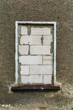 Brick up Window Frame on a Concrete Wall eviction concept Stock Photos