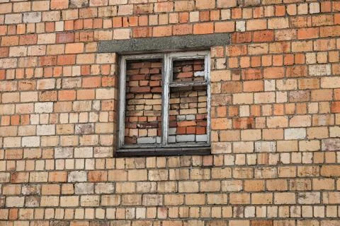 Bricked up window on a brick wall. Immured window Stock Photos