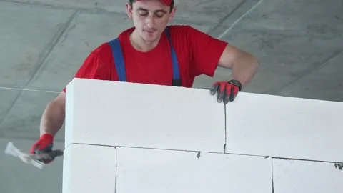 Bricklayer builder working with autoclaved aerated concrete blocks. Walling Stock Footage 88028150