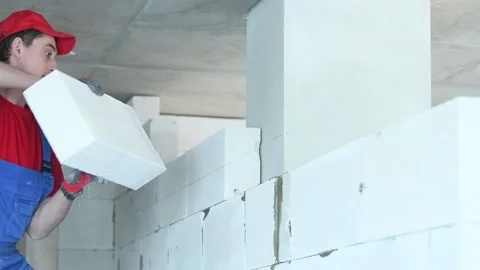 Bricklayer builder working with autoclaved aerated concrete blocks. Walling Stock Footage 88028157