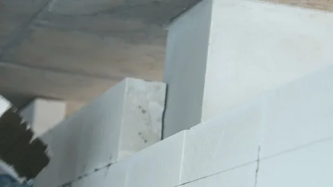 Bricklayer builder working with autoclaved aerated concrete blocks. Walling Video stock 94389458