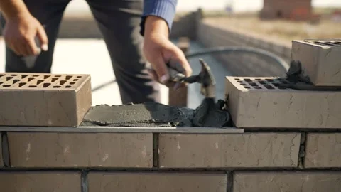 Bricklayer building a wall with bricks and mortar Stock Footage 326066242