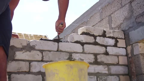 Bricklayer building wall with mortar and trowel Stock Footage 310044655