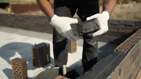 Bricklayer building a wall with mortar and bricks Stock Footage 326066219