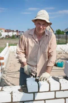 Bricklayer builds a wall Stock Photos
