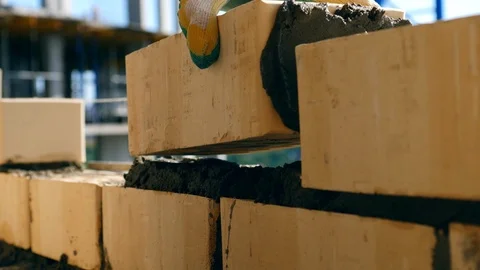 Bricklayer doing brickwork at a construction site. A bricklayer works at a site Stock-Footage 117067321