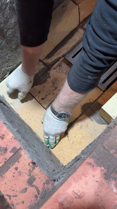 Bricklayer fitting a fireclay brick in the masonry, Making the core of a he.. Stock Footage 321837736