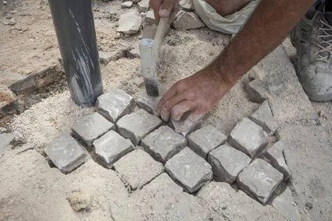 Bricklayer fixing portuguese pavement Stock Photos