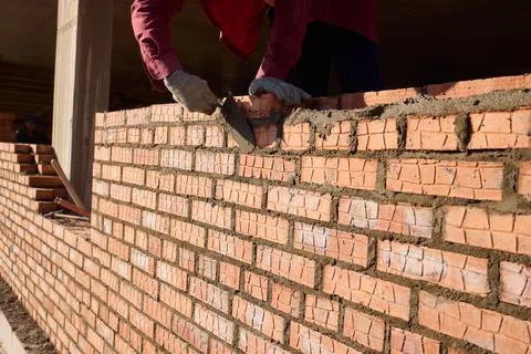 Bricklayer Hard at Work Ongoing Construction of a Residential Building Structure Stock Photos