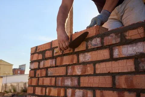Bricklayer Hard at Work Ongoing Construction of a Residential Building Structure Stock Photos