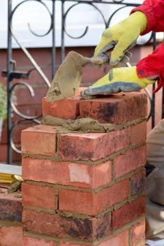 Bricklayer laying brick Stock Photos