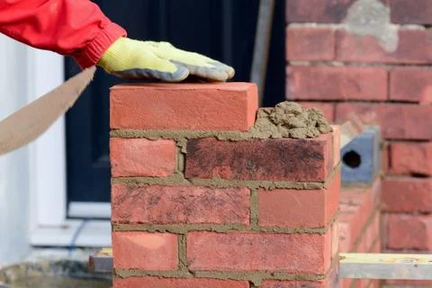 Bricklayer laying brick Stock Photos