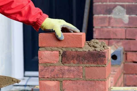 Bricklayer laying brick Stock Photos