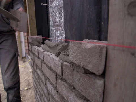 Bricklayer laying bricks at building site in Europe, close up 4K Stock Footage 75807334