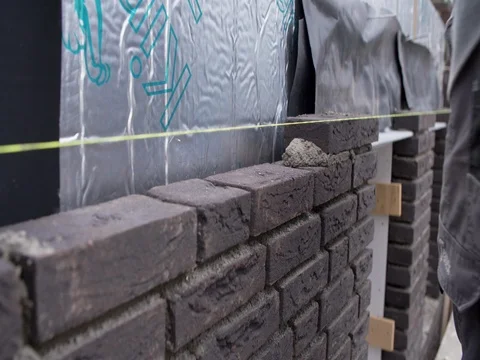Bricklayer laying bricks at building site in Europe, close up 4K Stock Footage 75808089