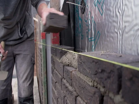 Bricklayer laying bricks at building site in Europe, close shot 4K Stock Footage 75808380
