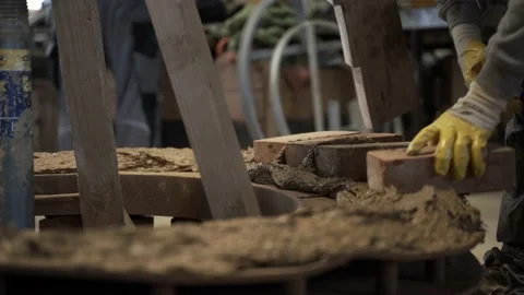 Bricklayer Laying Bricks on Clay Mixture, Building Bell Casting Mold. Stock Footage 221425512