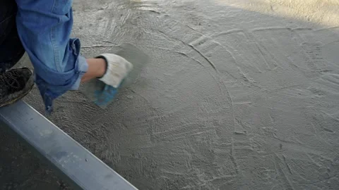 Bricklayer laying concrete To create a cement floor inside the house Video stock 283066424