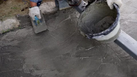 Bricklayer laying concrete To create a cement floor inside the house Video stock 283066445
