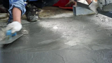 Bricklayer laying concrete To create a cement floor inside the house Video stock 283066629