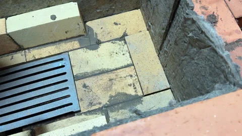 Bricklayer laying fireclay brick in the core of a heating stove, Adjusting .. Stock Footage 321837819