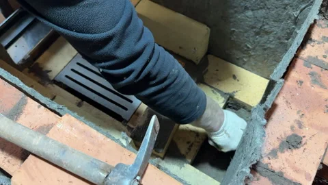Bricklayer laying fireclay brick in the core of a heating stove, Building a.. Stock Footage 321837890