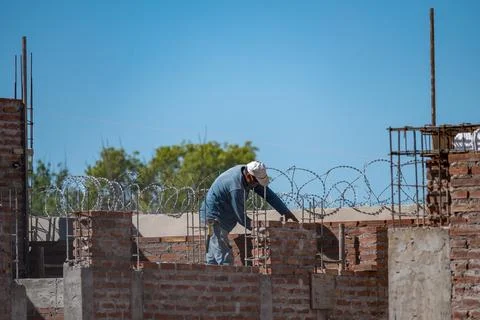 Bricklayer laying mud bricks in house construction in Argentina. Stock Photos
