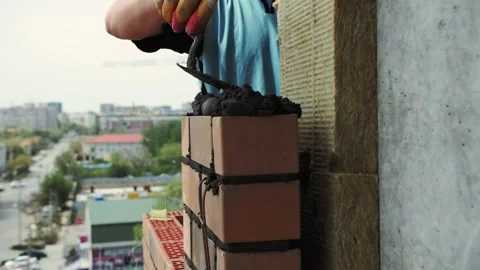 Bricklayer lays bricks, exterior wall Stock Footage 192474576