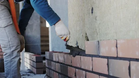 Bricklayer lays bricks, exterior wall Stock Footage 194850910
