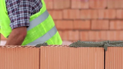 Bricklayer lays construction bricks Stock Footage 208562475
