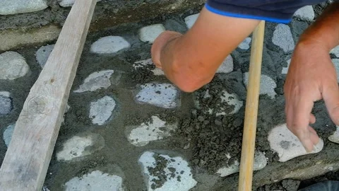 A bricklayer lays stones on a path. Stock Footage 134611287