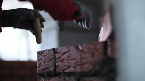 Bricklayer leveling fresh brickwork with spirit level Stock Footage 323445462