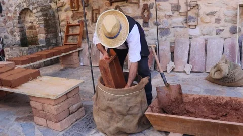 Bricklayer making adobe bricks Stock Footage 245223330