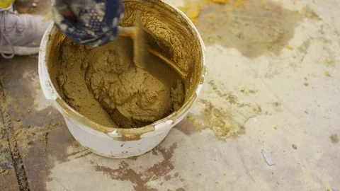 Bricklayer mixing cement in a bucket Stock-Footage 111188959