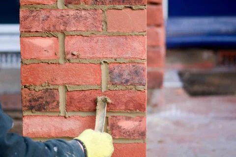 Bricklayer pointing render on wall Stock Photos