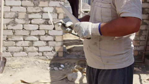Bricklayer preparing mortar with trowel at wall Stock Footage 310043165