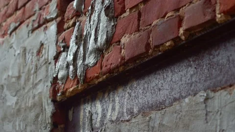 A bricklayer puts plaster on a brick wall. Plastering cement at wall. Stock Footage 188232325