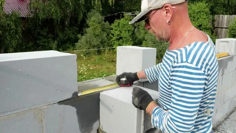 Bricklayer putting down another row of bricks in site Stock Footage 113385926